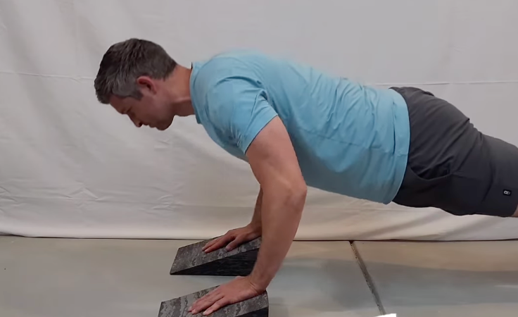 Performing slanted pushups for wrist safety