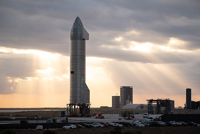 Starship SN9 on the launch pad with construction site